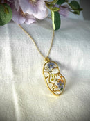 Pendant with abstract figure in resin and real flowers. Forget-me-not flowers, queen's lace. Woman face resin necklace