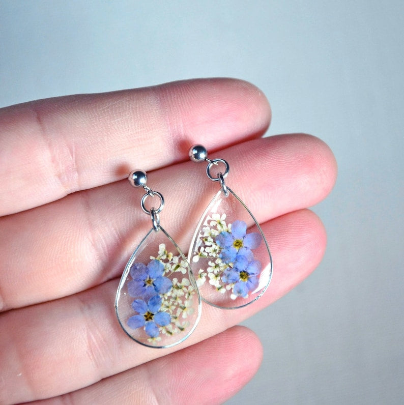 Drop resin earrings with forget-me-not flowers. Forget-me-not earrings and white lace. Real flowers do not forget me.