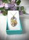 Pendant with abstract figure in resin and real flowers. Forget-me-not flowers, queen's lace. Woman face resin necklace